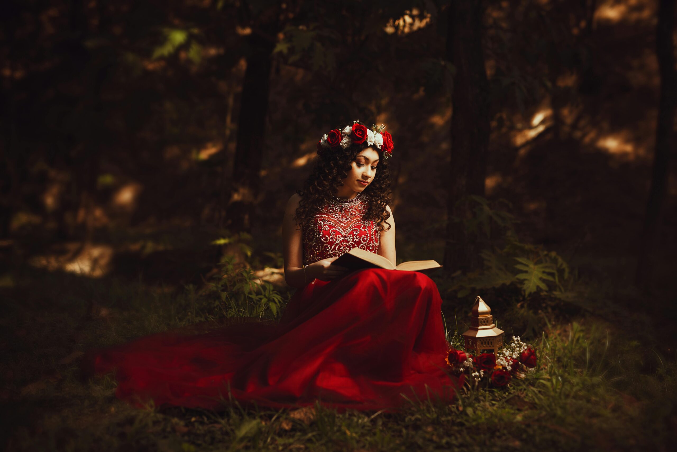 lady in red in the forest, reading a book