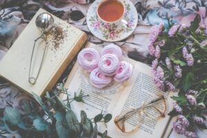 a book, a cup of tea, and sweets